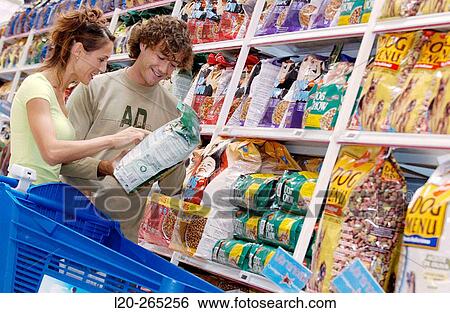 Couple buying dog food at shopping center View Large Photo Image Stock Photograph - Couple buying dog food at shopping center. Fotosearch