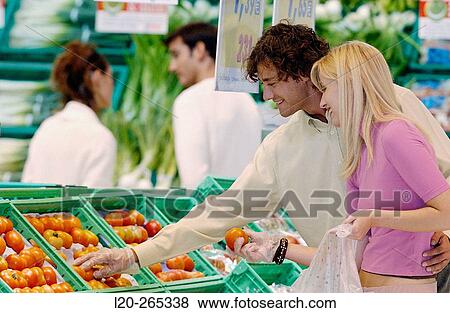 Couple buying fruit View Large Photo Image Stock Photo - Couple buying fruit. Fotosearch