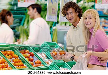 Couple buying fruit View Large Photo Image Stock Photo - Couple buying fruit. Fotosearch