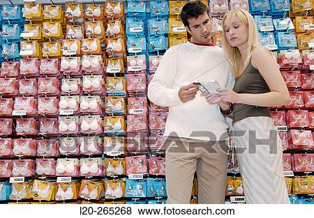 Couple buying light bulbs at shopping center View Large Photo Image Stock Photo - Couple buying light bulbs at shopping center. Fotosearch