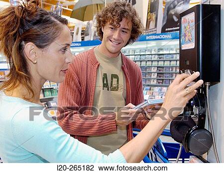 Couple buying music CD at shopping center View Large Photo Image Stock Image - Couple buying music CD at shopping center. Fotosearch