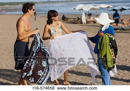 couple buying sarong from native seller View Large Photo Image Stock Photo - couple buying sarong from native seller. Fotosearch