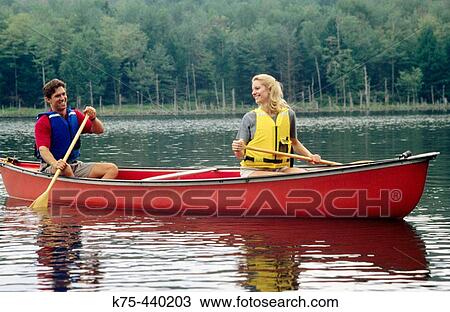 Couple canoeing on lake View Large Photo Image Stock Image - Couple canoeing on lake. Fotosearch