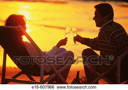 Couple celebrating at the beach View Large Photo Image Stock Photograph - Couple celebrating at the beach. Fotosearch