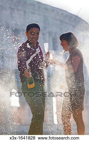 Stock Photo - Couple celebrating with champagne. Fotosearch