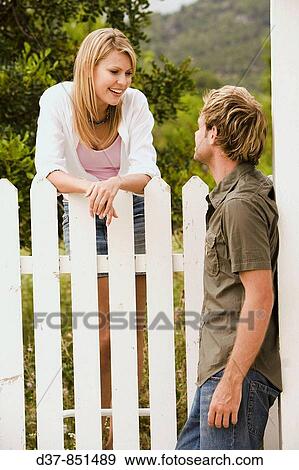 Stock Photo - Couple chatting in the garden. Fotosearch