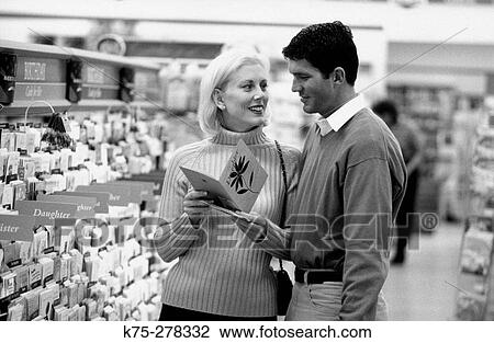 Couple choosing a card View Large Photo Image Stock Image - Couple choosing a card. Fotosearch