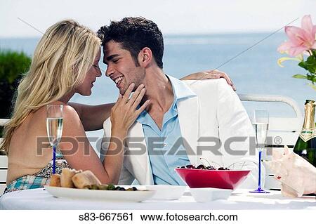 Couple dining at beach about to kiss View Large Photo Image Stock Image - Couple dining at beach about to kiss. Fotosearch