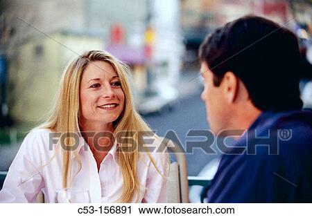 Stock Image - Couple dining outside. Fotosearch