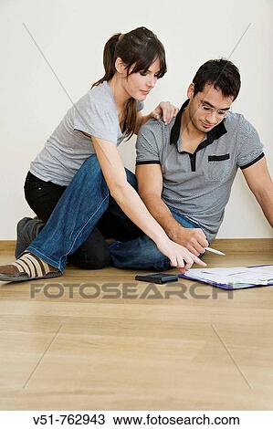 Stock Image - Couple doing finances at home. Fotosearch