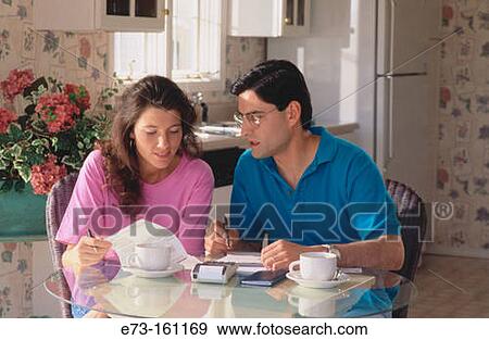 Stock Photo - Couple doing home finances. Fotosearch
