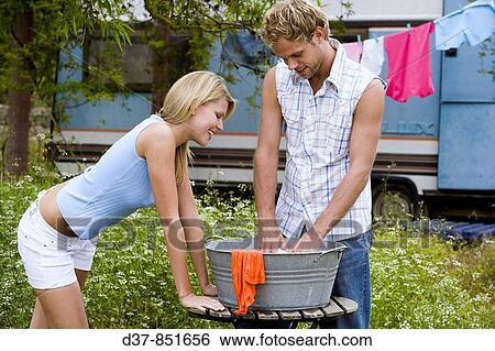 Couple doing the washing in a camping View Large Photo Image Stock Photograph - Couple doing the washing in a camping. Fotosearch