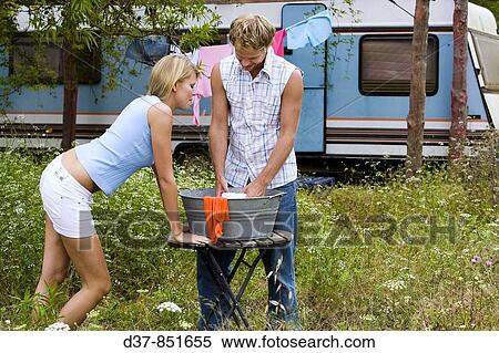 Couple doing the washing outdoors View Large Photo Image Stock Photography - Couple doing the washing outdoors. Fotosearch
