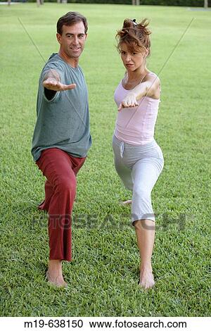 Couple doing yoga together View Large Photo Image Stock Image - Couple doing yoga together. Fotosearch