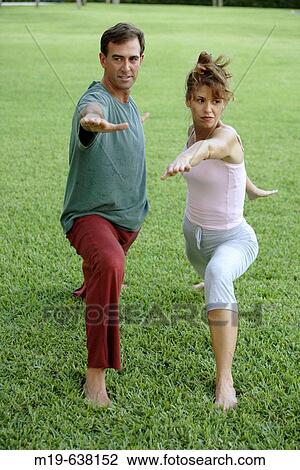 Couple doing yoga together View Large Photo Image Stock Image - Couple doing yoga together. Fotosearch