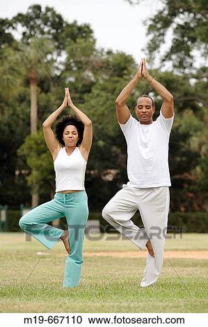 Couple doing yoga together View Large Photo Image Stock Image - Couple doing yoga together. Fotosearch
