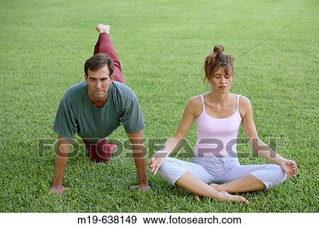 Couple doing yoga together View Large Photo Image Stock Photo - Couple doing yoga together. Fotosearch
