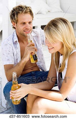 Couple drinking a beer View Large Photo Image Stock Image - Couple drinking a beer. Fotosearch