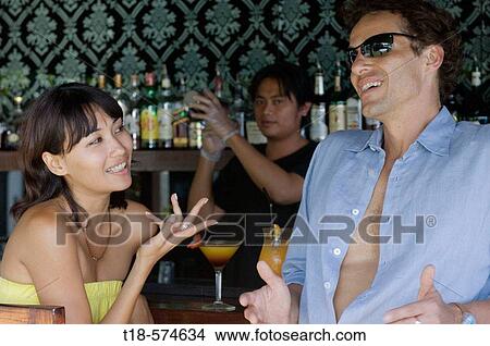 couple drinking and talking at bar View Large Photo Image Picture - couple drinking and talking at bar. Fotosearch
