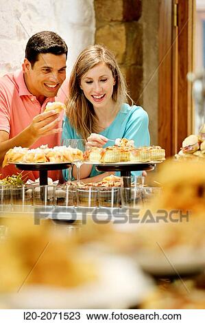 Couple drinking wine and eating tapas. Pintxos. Bar txondorra. Parte Vieja. Old town. San Sebastian. Donostia. Gipuzkoa. Basque Country. Spain. View Large Photo Image Stock Image - Couple drinking wine and eating tapas. Pintxos. Bar txondorra. Parte Vieja. Old town. San Sebastian. Donostia. Gipuzkoa. Basque Country. Spain.. Fotosearch