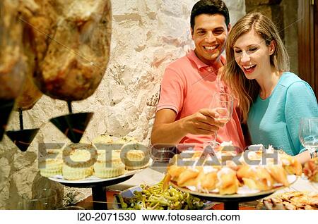Couple drinking wine and eating tapas. Pintxos. Bar txondorra. Parte Vieja. Old town. San Sebastian. Donostia. Gipuzkoa. Basque Country. Spain. View Large Photo Image Stock Image - Couple drinking wine and eating tapas. Pintxos. Bar txondorra. Parte Vieja. Old town. San Sebastian. Donostia. Gipuzkoa. Basque Country. Spain.. Fotosearch