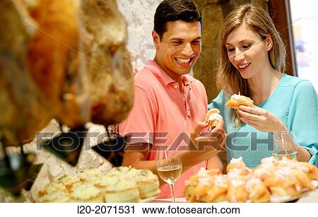 Couple drinking wine and eating tapas. Pintxos. Bar txondorra. Parte Vieja. Old town. San Sebastian. Donostia. Gipuzkoa. Basque Country. Spain. View Large Photo Image Stock Image - Couple drinking wine and eating tapas. Pintxos. Bar txondorra. Parte Vieja. Old town. San Sebastian. Donostia. Gipuzkoa. Basque Country. Spain.. Fotosearch