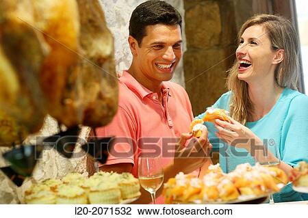 Couple drinking wine and eating tapas. Pintxos. Bar txondorra. Parte Vieja. Old town. San Sebastian. Donostia. Gipuzkoa. Basque Country. Spain. View Large Photo Image Stock Image - Couple drinking wine and eating tapas. Pintxos. Bar txondorra. Parte Vieja. Old town. San Sebastian. Donostia. Gipuzkoa. Basque Country. Spain.. Fotosearch