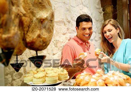Couple drinking wine and eating tapas. Pintxos. Bar txondorra. Parte Vieja. Old town. San Sebastian. Donostia. Gipuzkoa. Basque Country. Spain. View Large Photo Image Stock Photo - Couple drinking wine and eating tapas. Pintxos. Bar txondorra. Parte Vieja. Old town. San Sebastian. Donostia. Gipuzkoa. Basque Country. Spain.. Fotosearch