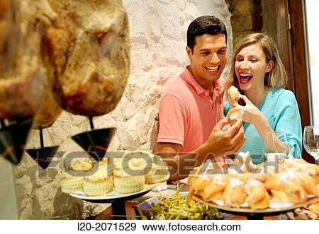 Couple drinking wine and eating tapas. Pintxos. Bar txondorra. Parte Vieja. Old town. San Sebastian. Donostia. Gipuzkoa. Basque Country. Spain. View Large Photo Image Stock Photo - Couple drinking wine and eating tapas. Pintxos. Bar txondorra. Parte Vieja. Old town. San Sebastian. Donostia. Gipuzkoa. Basque Country. Spain.. Fotosearch