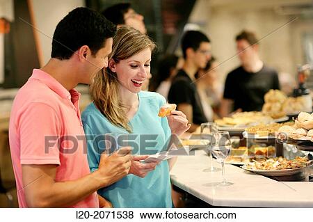 Couple drinking wine and eating tapas. Pintxos. Bar txondorra. Parte Vieja. Old town. San Sebastian. Donostia. Gipuzkoa. Basque Country. Spain. View Large Photo Image Stock Photo - Couple drinking wine and eating tapas. Pintxos. Bar txondorra. Parte Vieja. Old town. San Sebastian. Donostia. Gipuzkoa. Basque Country. Spain.. Fotosearch