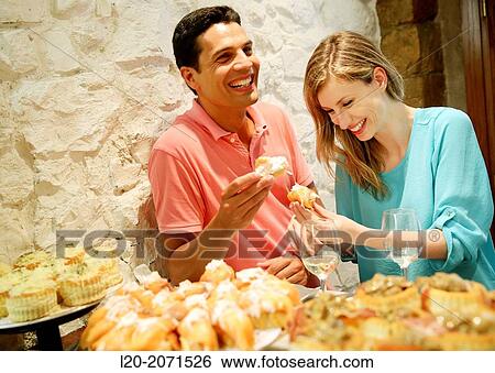 Couple drinking wine and eating tapas. Pintxos. Bar txondorra. Parte Vieja. Old town. San Sebastian. Donostia. Gipuzkoa. Basque Country. Spain. View Large Photo Image Stock Photograph - Couple drinking wine and eating tapas. Pintxos. Bar txondorra. Parte Vieja. Old town. San Sebastian. Donostia. Gipuzkoa. Basque Country. Spain.. Fotosearch