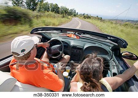 Couple driving in a convertible in Kauai. USA View Large Photo Image Stock Image - Couple driving in a convertible in Kauai. USA. Fotosearch