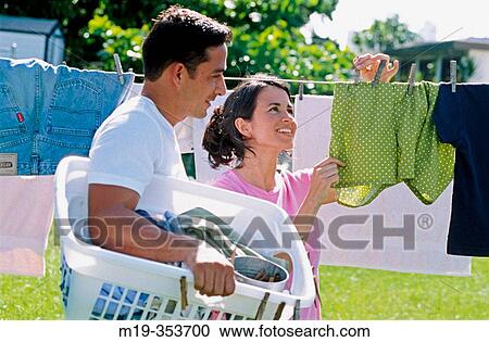Couple drying clothes View Large Photo Image Stock Image - Couple drying clothes. Fotosearch