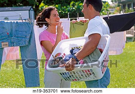 Couple drying clothes View Large Photo Image Stock Image - Couple drying clothes. Fotosearch