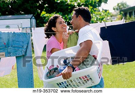 Couple drying clothes View Large Photo Image Stock Image - Couple drying clothes. Fotosearch