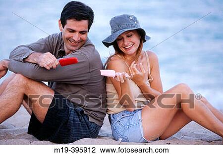 couple eating popsicales at the beach View Large Photo Image Stock Image - couple eating popsicales at the beach. Fotosearch
