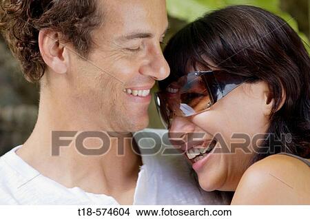 Picture - couple embracing and smiling. Fotosearch