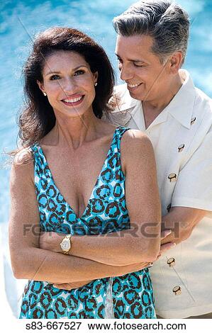 Stock Photo - Couple embracing each other by the pool. Fotosearch