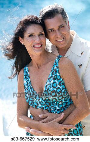 Couple embracing each other by the pool. View Large Photo Image Stock Photo - Couple embracing each other by the pool.. Fotosearch