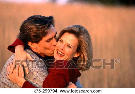 Picture - couple embracing in the countryside. Fotosearch