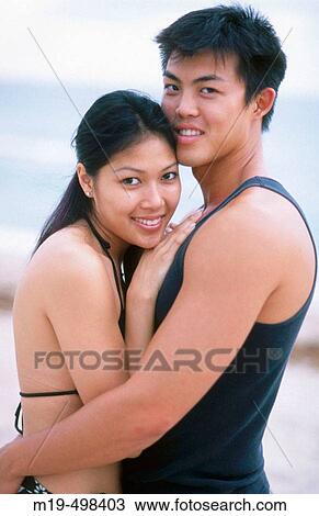 couple embracing on a beach View Large Photo Image Stock Image - couple embracing on a beach. Fotosearch
