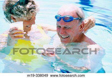couple enjoying a drink in the pool View Large Photo Image Stock Photo - couple enjoying a drink in the pool. Fotosearch