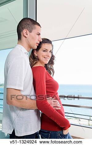 Couple enjoying the views from home View Large Photo Image Picture - Couple enjoying the views from home. Fotosearch