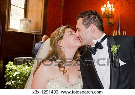Stock Image - Couple exchanging wedding rings at Town Hall in Rome, Italy. Fotosearch