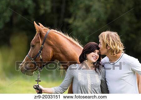 Couple flilrting with horse in the background, Stellenbosch region, Cape Town, Western Cape, South Africa. View Large Photo Image Stock Image - Couple flilrting with horse in the background, Stellenbosch region, Cape Town, Western Cape, South Africa.. Fotosearch