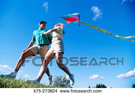 Picture - Couple flying kite. Fotosearch