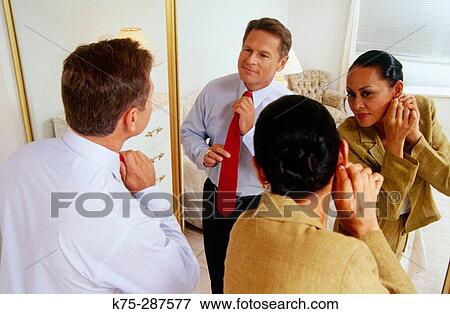 Stock Photo - couple getting ready to go out. Fotosearch
