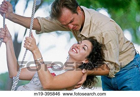 couple- girl is on a swing View Large Photo Image Stock Photograph - couple- girl is on a swing. Fotosearch