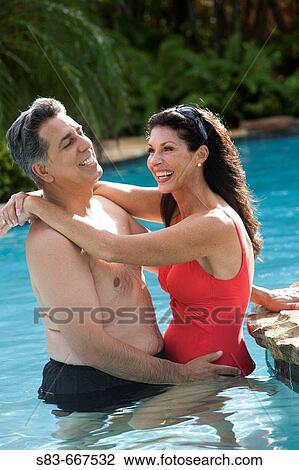 Couple hanging out in pool View Large Photo Image Stock Image - Couple hanging out in pool. Fotosearch