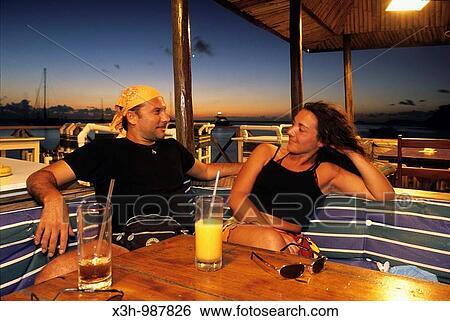 couple having a drink at Basil's bar, Mustik, Grenadines islands, Saint Vincent and the Grenadines, Winward Islands, Lesser Antilles, Caribbean Sea View Large Photo Image Stock Photograph - couple having a drink at Basil's bar, Mustik, Grenadines islands, Saint Vincent and the Grenadines, Winward Islands, Lesser Antilles, Caribbean Sea. Fotosearch